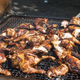 Black chef grilling barbecue chicken